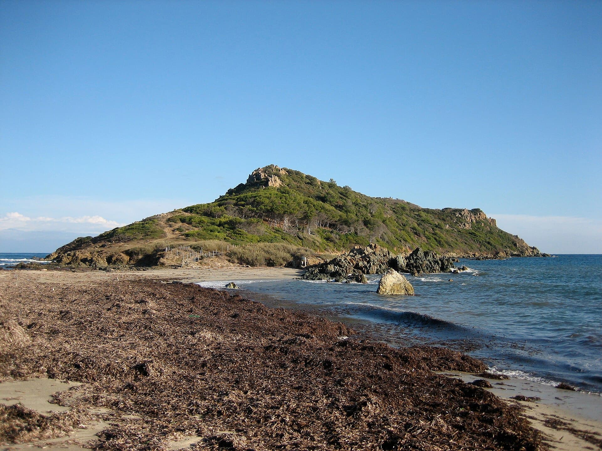 Cap Taillat from the sea — sandy peninsula between two turquoise bays