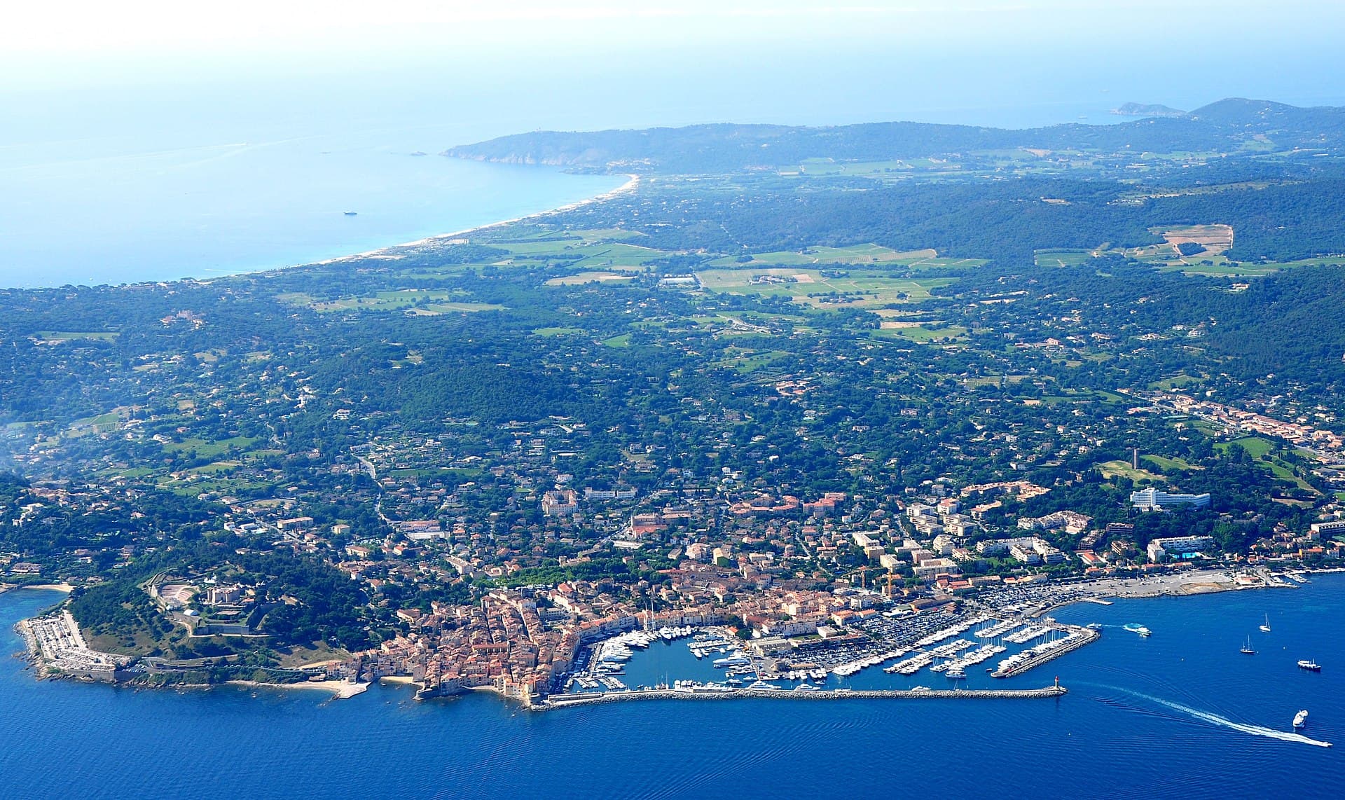 Saint-Tropez Old Port seen from the sea — yachts moored along pastel façades